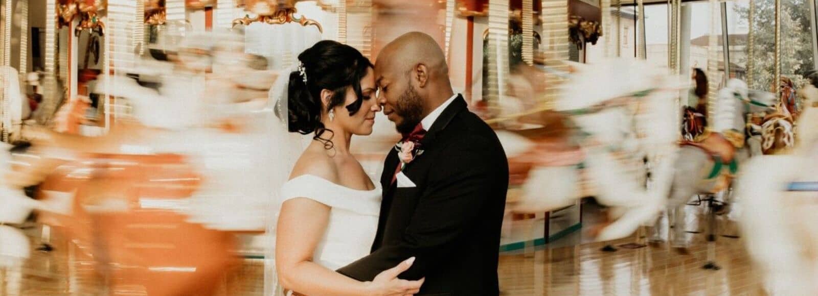 Bride and groom at carousel