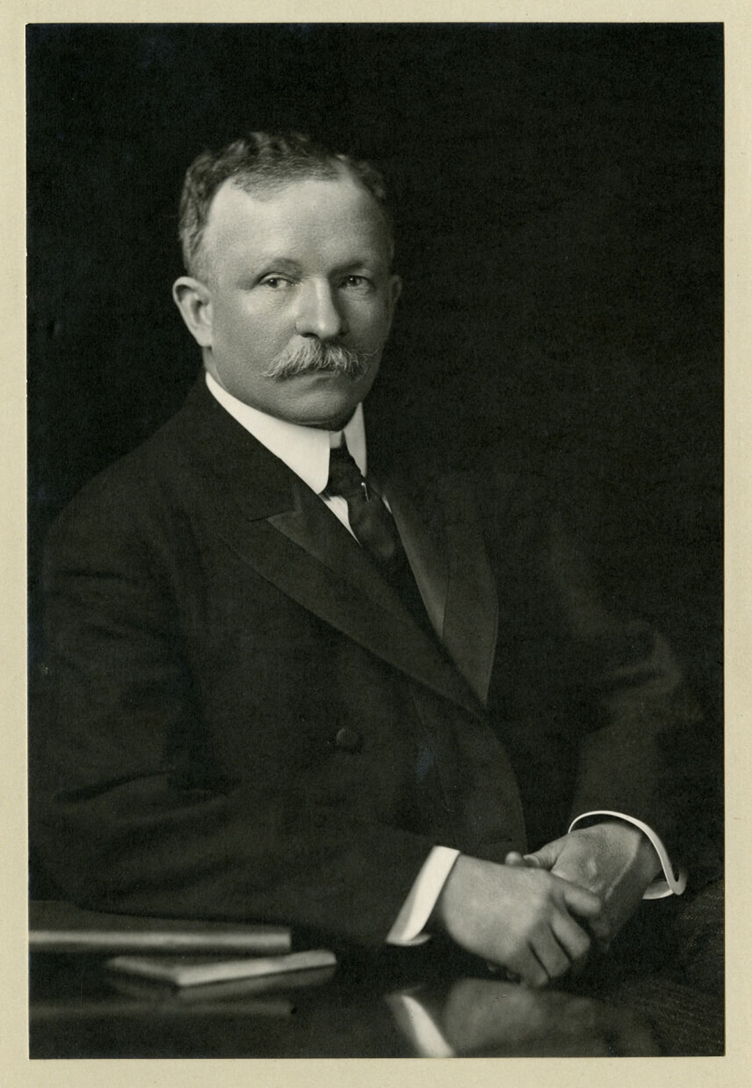 Portraitofcharleschesnuttleaningonstackofbooks